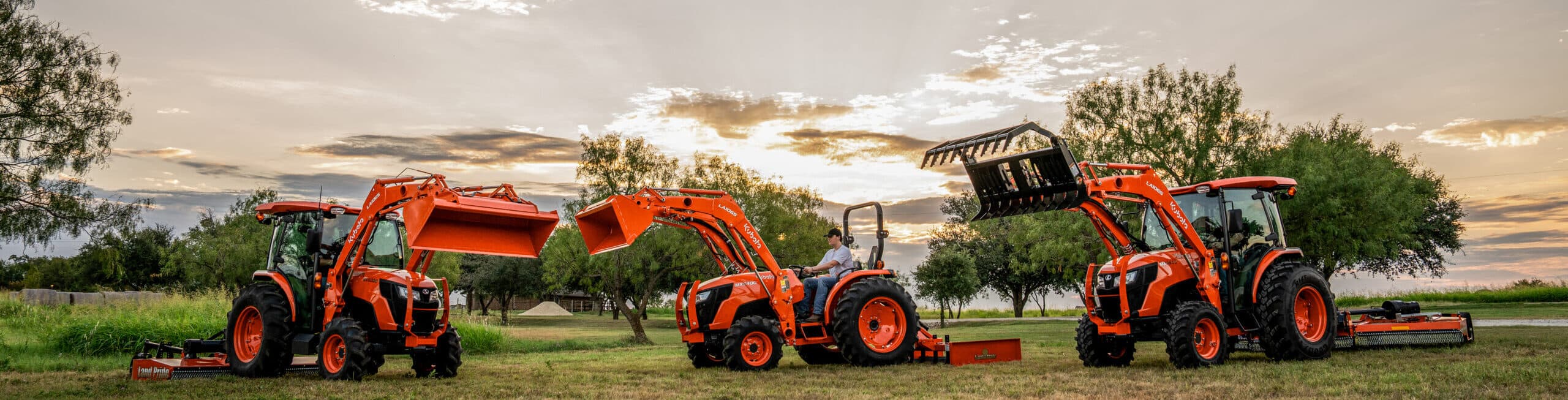 A selection of different tractors with different attachments and implements being displayed for tractor packages